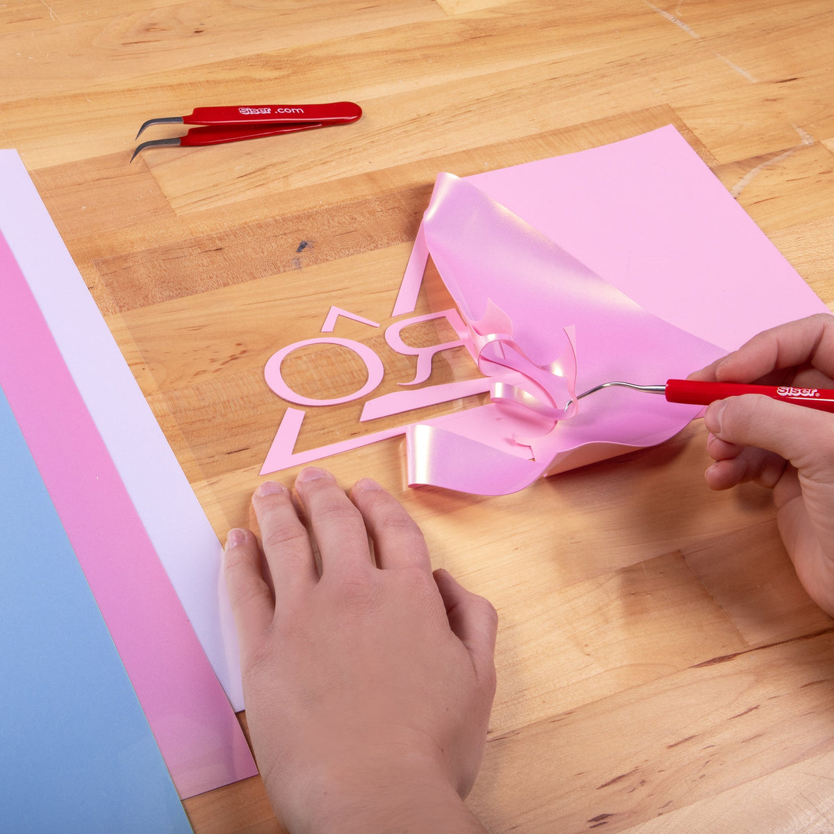 Weeding a Brick 600 Pearl Pink heat transfer vinyl design