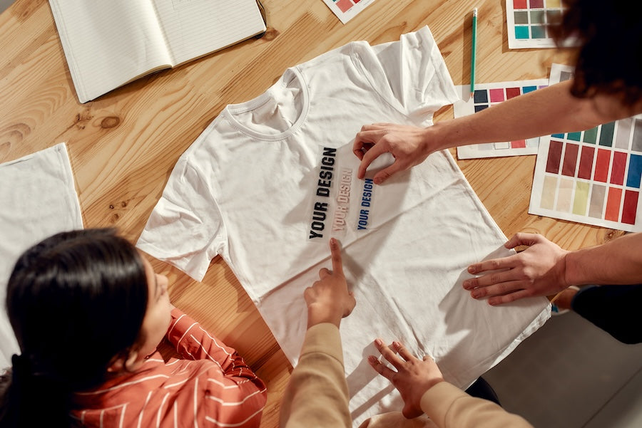 3 people working together to design their custom t shirts