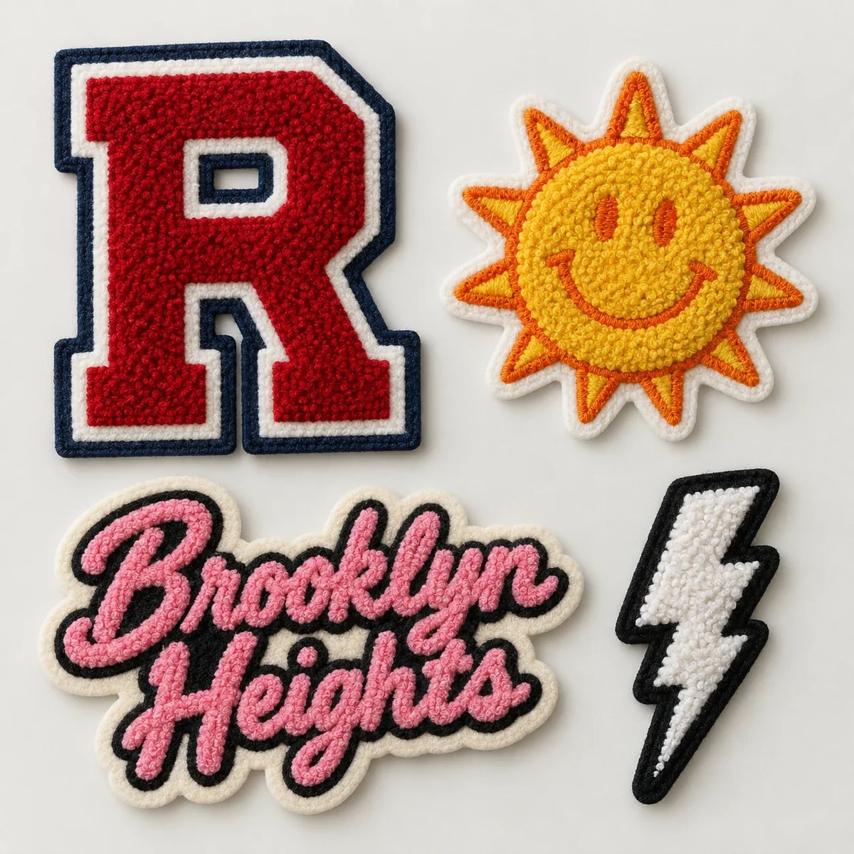 Assorted custom chenille patches including a varsity letter and script patch