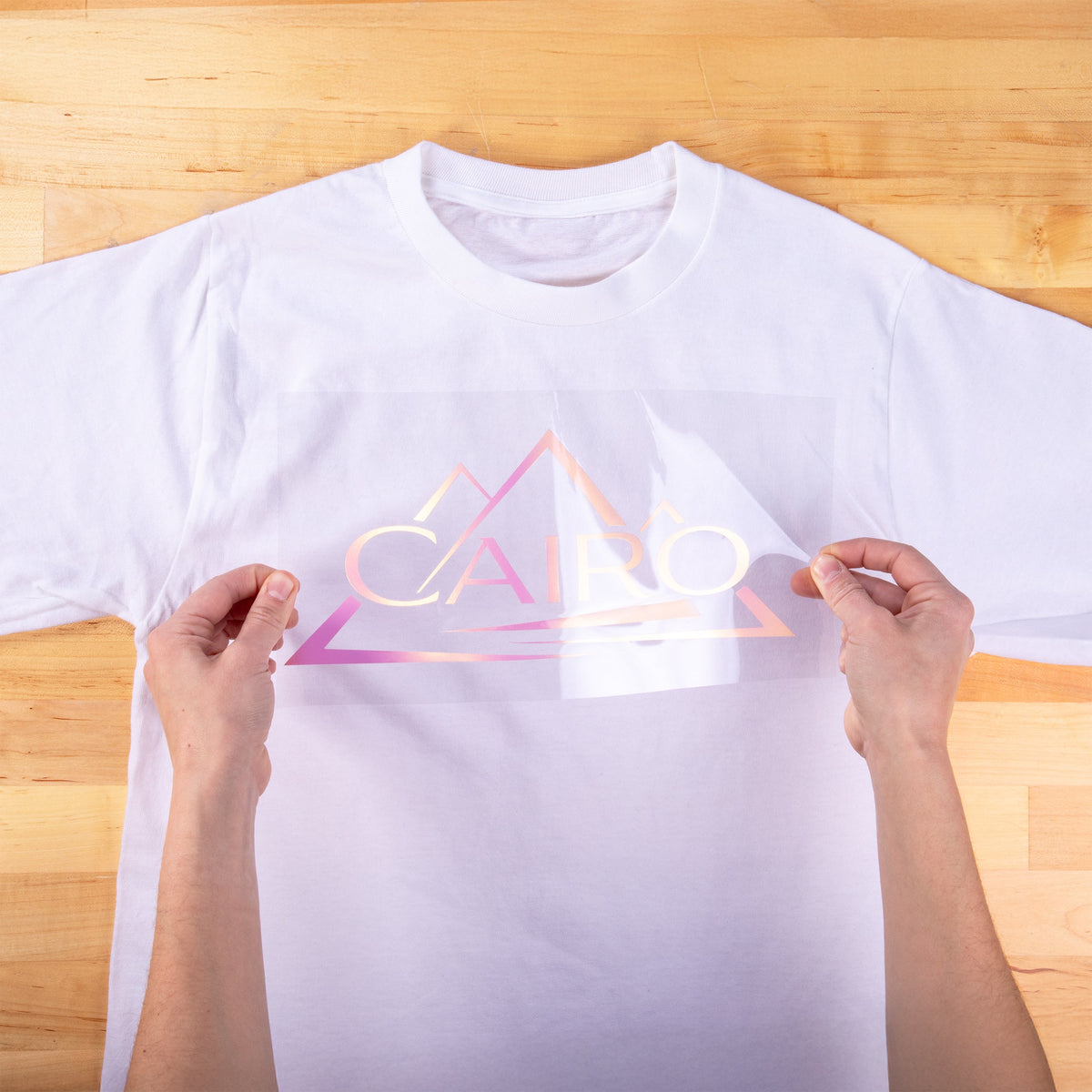 Brick 600 Pearl transfer being applied to a white t-shirt