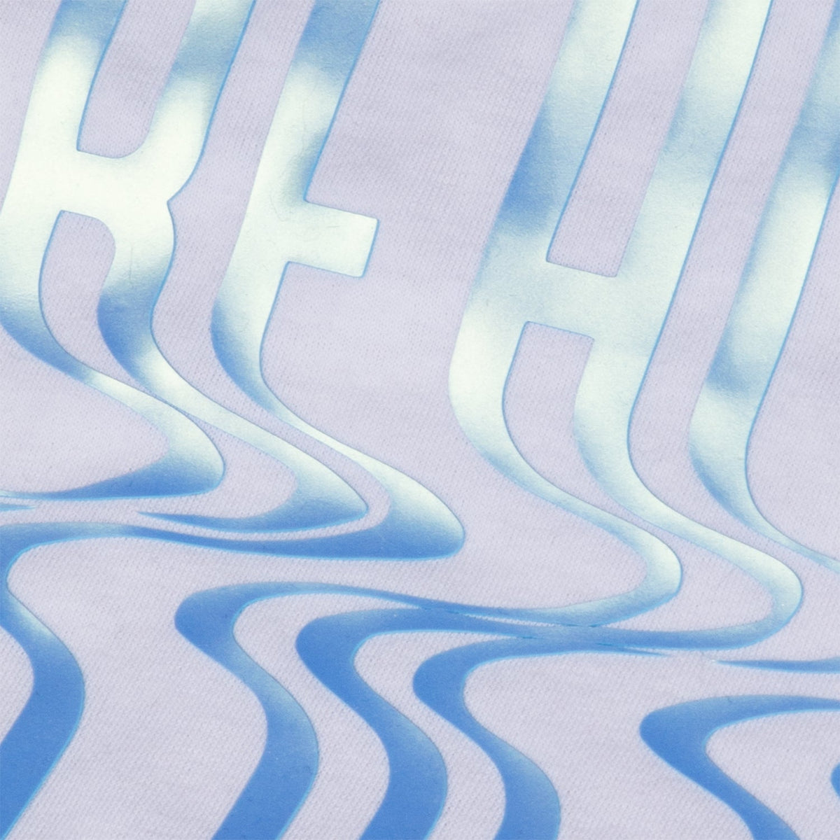 Close up of raised Brick 600 Pearl Blue design pressed on a white tee