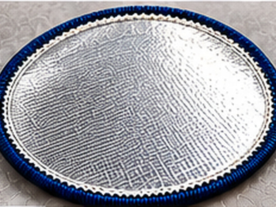 Underside of an iron-on custom patch showing a shiny heat-activated adhesive backing